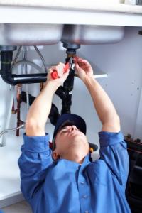 Plumber fixes a kitchen sink in Lakewood, Washington